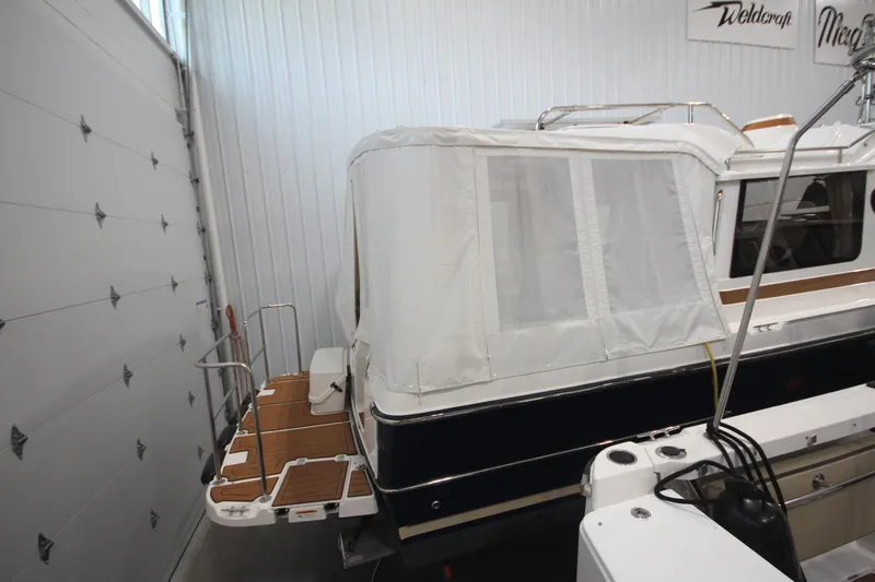Patrick Mcginty Yacht Photos Pics 2022 Ranger Tugs R-29 Sedan Luxury Edition in storage, featuring covered deck area.