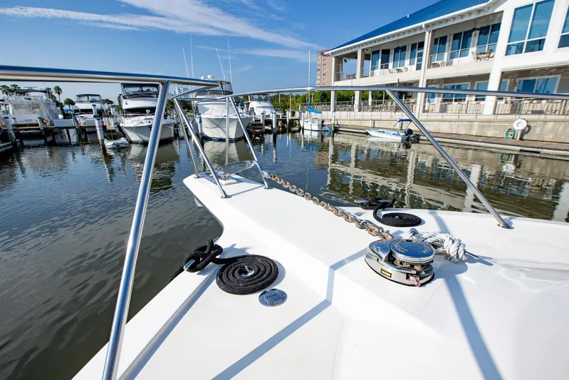Scallywag Yacht Photos Pics 1991 Ocean Yachts 42 Super Sport docked at a marina, showcasing its bow and anchor chain.