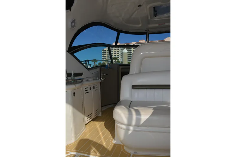 Knot On Call Yacht Photos Pics Interior of 2007 Sea Ray 44 Sundancer yacht with white seating and kitchenette.
