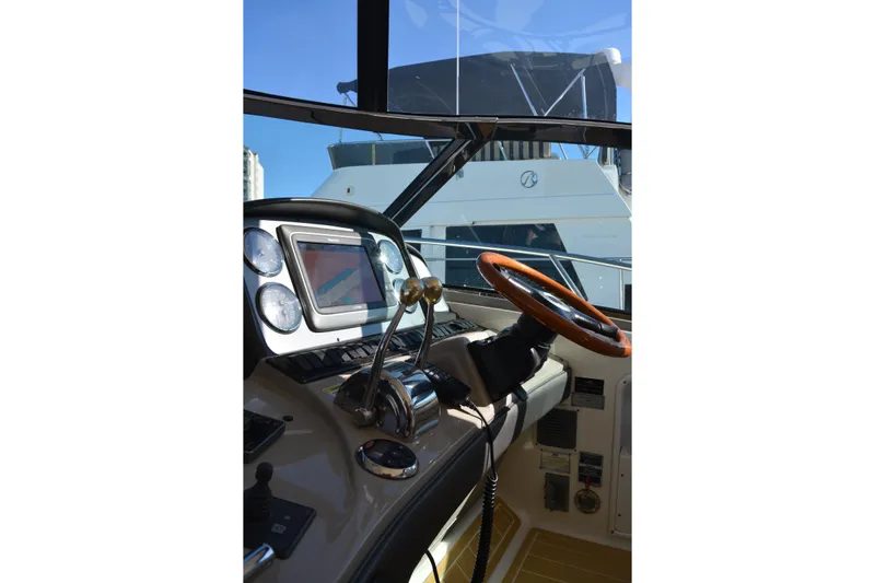 Knot On Call Yacht Photos Pics 2007 Sea Ray 44 Sundancer helm with steering wheel and navigation controls.