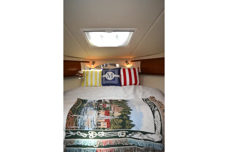 Knot On Call Yacht Photos Pics Cozy cabin interior of 2007 Sea Ray 44 Sundancer with decorative pillows and blanket.