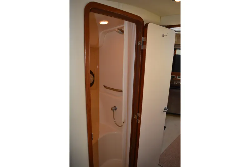Knot On Call Yacht Photos Pics Shower area inside 2007 Sea Ray 44 Sundancer yacht, featuring wooden trim and modern fixtures.