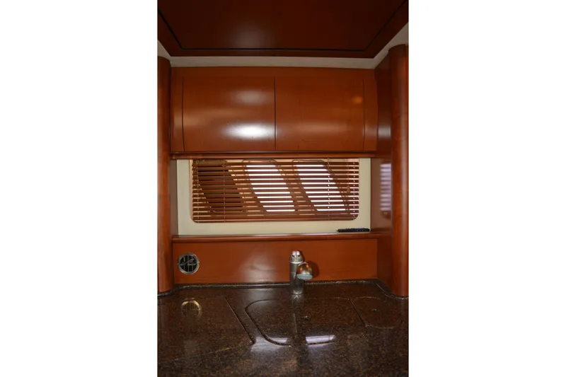 Knot On Call Yacht Photos Pics Interior of 2007 Sea Ray 44 Sundancer yacht with wooden cabinets and window blinds.