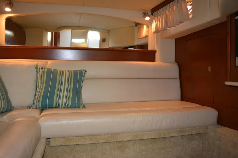 Knot On Call Yacht Photos Pics Luxurious interior of 2007 Sea Ray 44 Sundancer with cream leather seating and striped cushions.