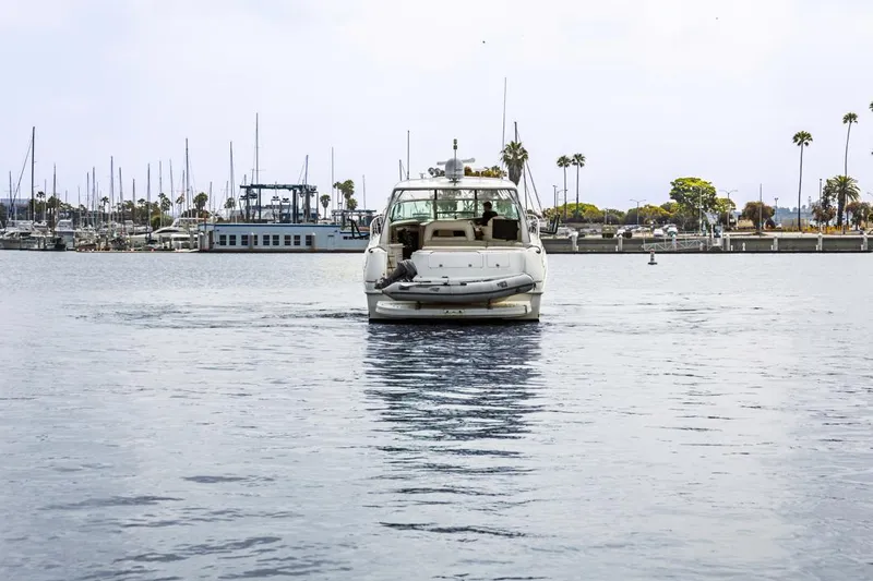  Yacht Photos Pics Sea Ray 510 Sundancer yacht from 2000 cruising in a marina with palm trees.