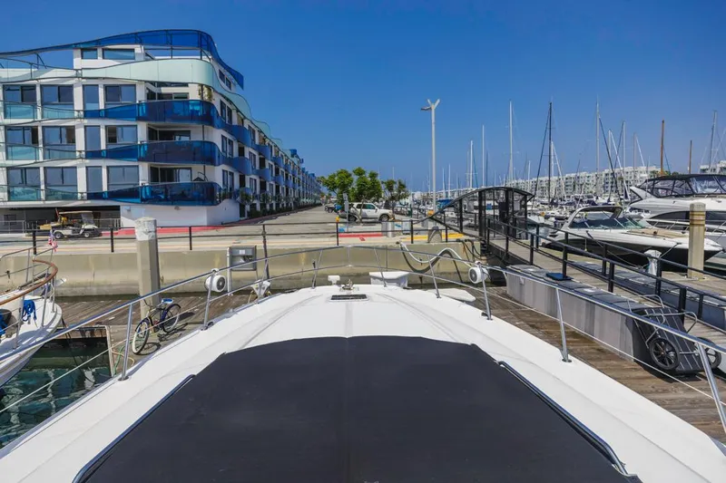  Yacht Photos Pics 2000 Sea Ray 510 Sundancer docked at marina with modern buildings and clear blue sky.