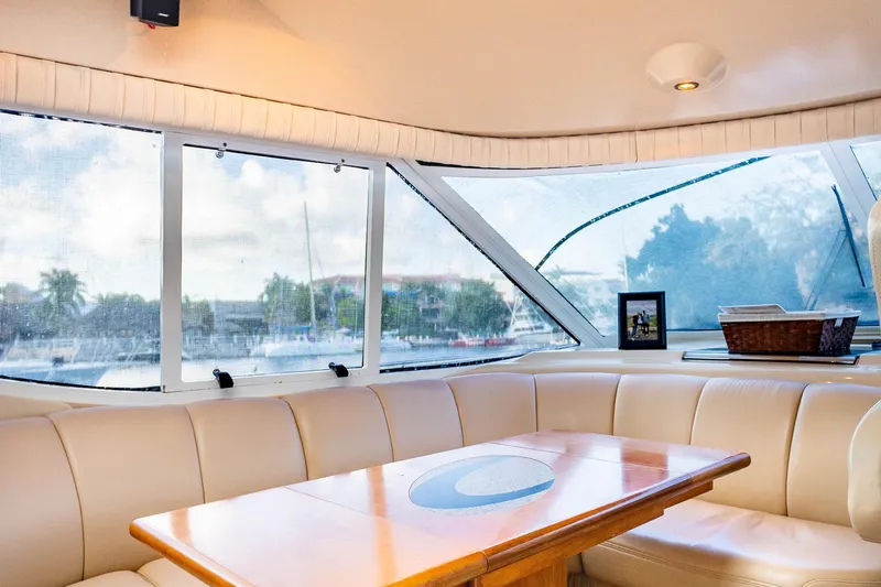  Yacht Photos Pics Interior of 2001 Cruisers Yachts 5000 Sedan Sport with leather seating and wooden table.