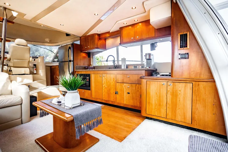  Yacht Photos Pics Luxurious interior of 2001 Cruisers Yachts 5000 Sedan Sport with elegant wood cabinetry.