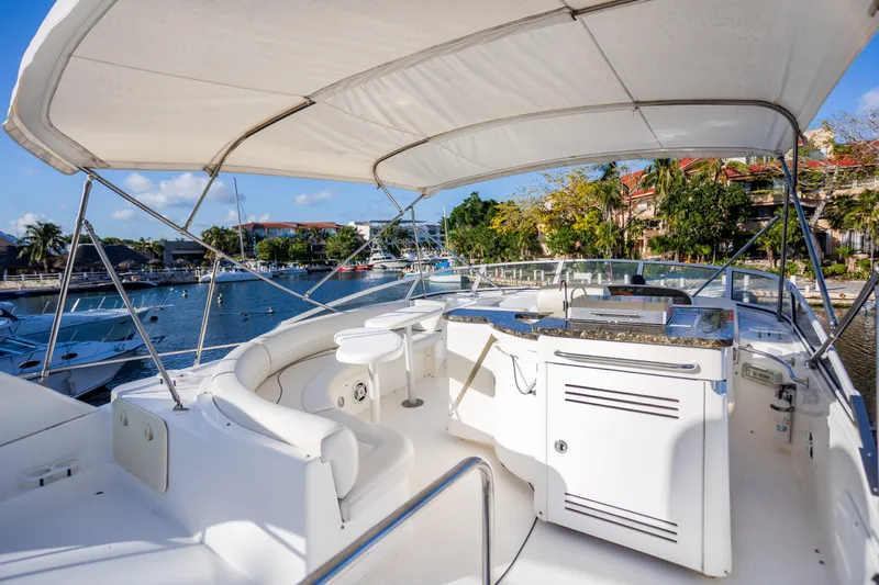  Yacht Photos Pics 2001 Cruisers Yachts 5000 Sedan Sport, spacious deck with seating, docked in marina.