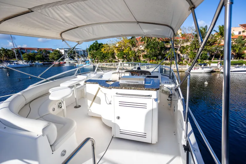  Yacht Photos Pics 2001 Cruisers Yachts 5000 Sedan Sport, luxurious deck view, marina backdrop.