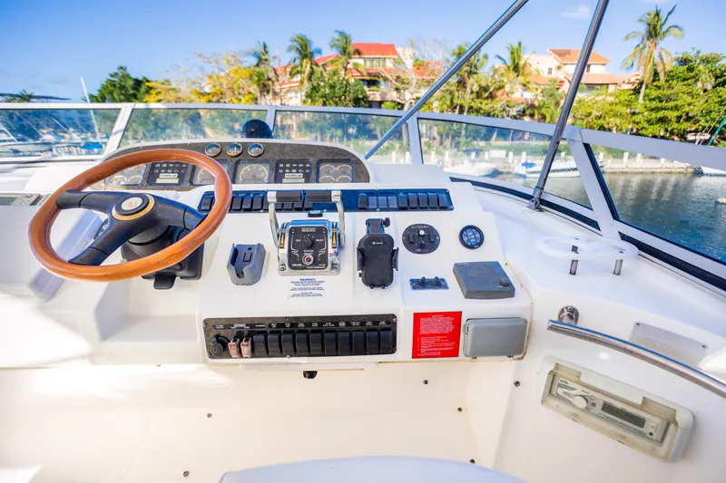  Yacht Photos Pics 2001 Cruisers Yachts 5000 Sedan Sport helm with wooden steering wheel and control panel.