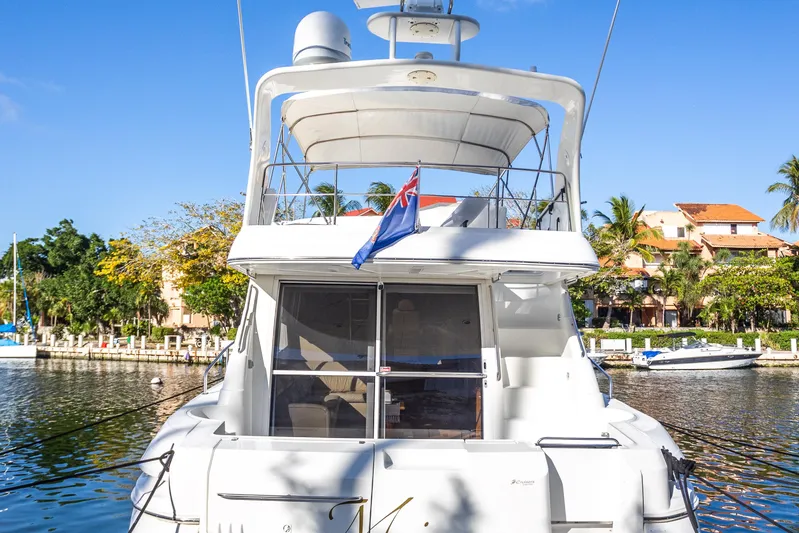  Yacht Photos Pics 2001 Cruisers Yachts 5000 Sedan Sport docked in sunny marina setting.