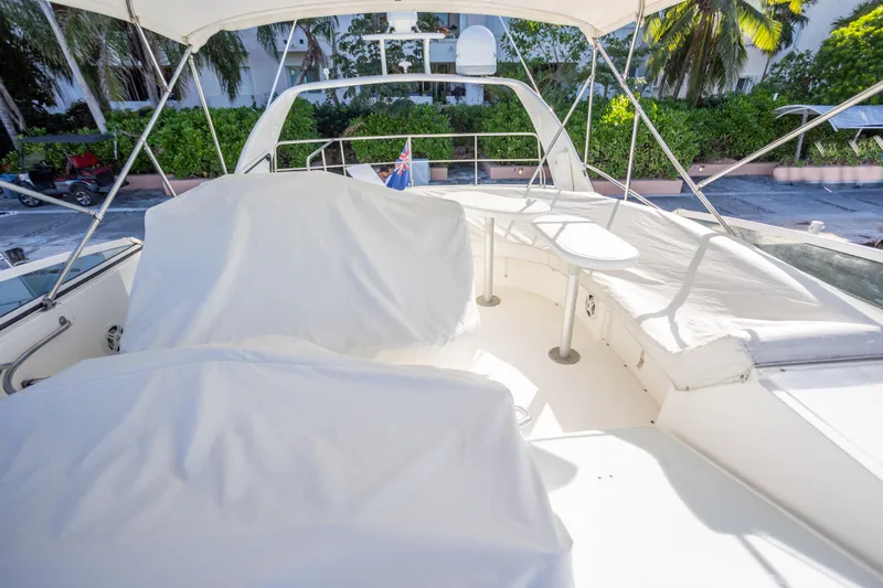  Yacht Photos Pics 2001 Cruisers Yachts 5000 Sedan Sport flybridge with covered seating and table.