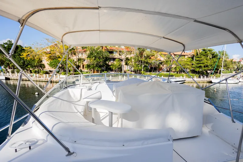  Yacht Photos Pics 2001 Cruisers Yachts 5000 Sedan Sport, docked with covered seating area, scenic marina view.