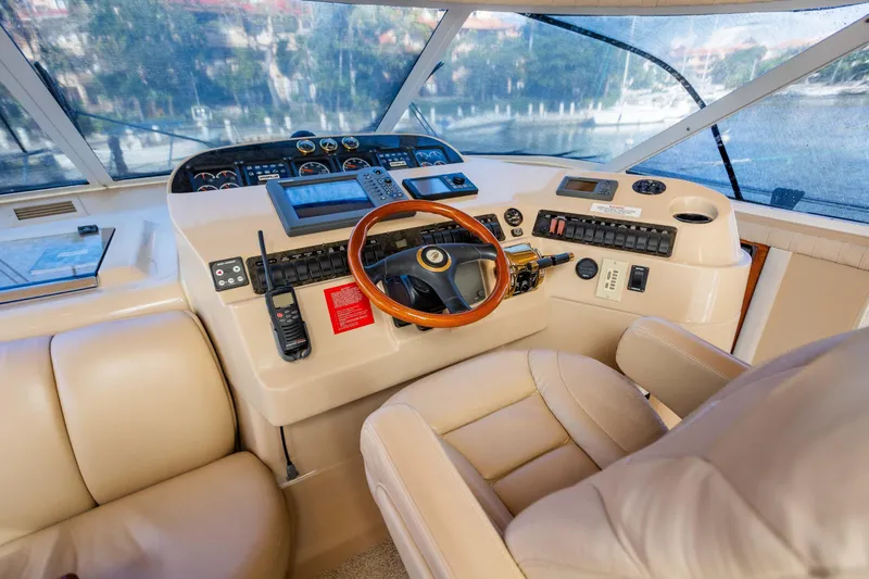  Yacht Photos Pics 2001 Cruisers Yachts 5000 Sedan Sport helm with leather seating and navigation controls.