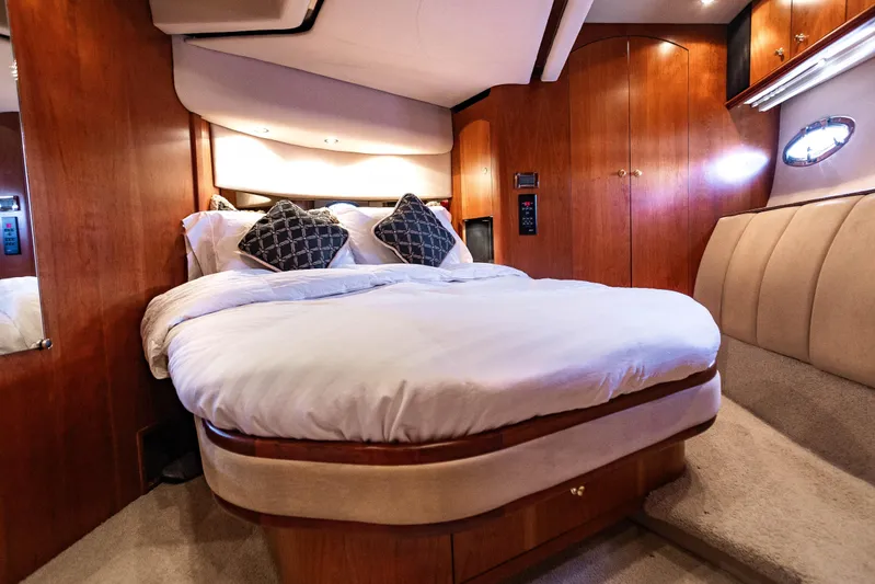  Yacht Photos Pics Luxurious bedroom interior of 2001 Cruisers Yachts 5000 Sedan Sport with elegant wood finish.