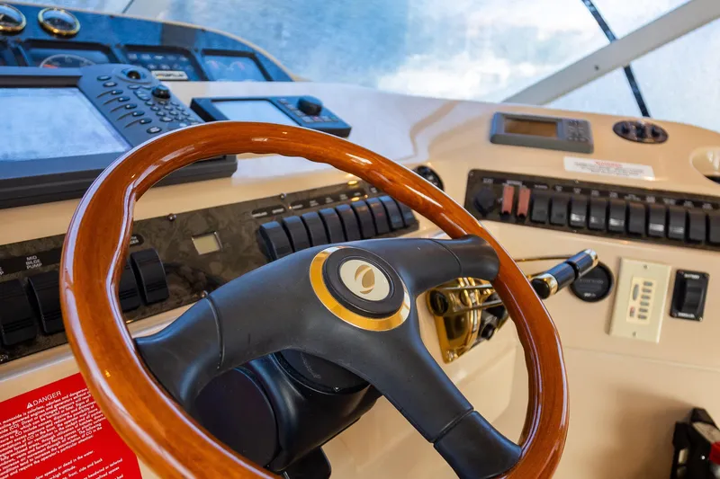  Yacht Photos Pics 2001 Cruisers Yachts 5000 Sedan Sport helm with wooden steering wheel and control panel.
