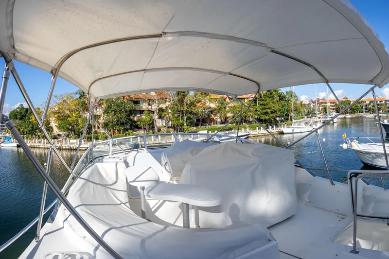  Yacht Photos Pics 2001 Cruisers Yachts 5000 Sedan Sport, covered deck, docked in a scenic marina.