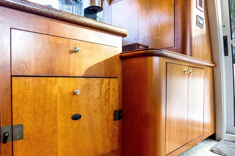  Yacht Photos Pics Interior of 2001 Cruisers Yachts 5000 Sedan Sport with polished wooden cabinetry.