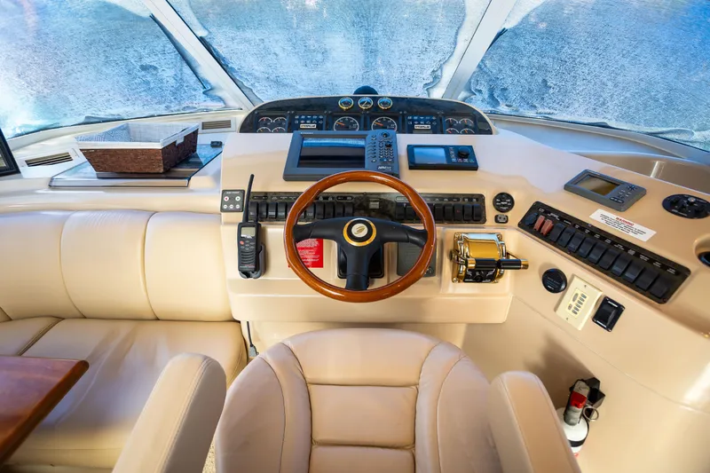  Yacht Photos Pics Interior helm of 2001 Cruisers Yachts 5000 Sedan Sport with leather seating and navigation controls.
