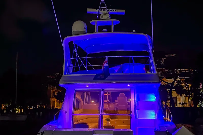 Mimosa Yacht Photos Pics 2001 Cruisers Yachts 5000 Sedan Sport illuminated at night with blue lights.