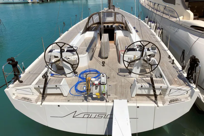 Nausicaä Yacht Photos Pics 2019 Solaris Yachts 55 sailboat with dual steering wheels, docked in a marina.