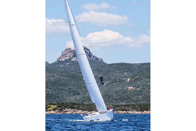Nausicaä Yacht Photos Pics 2019 Solaris Yachts 55 sailing near scenic coastal mountains.