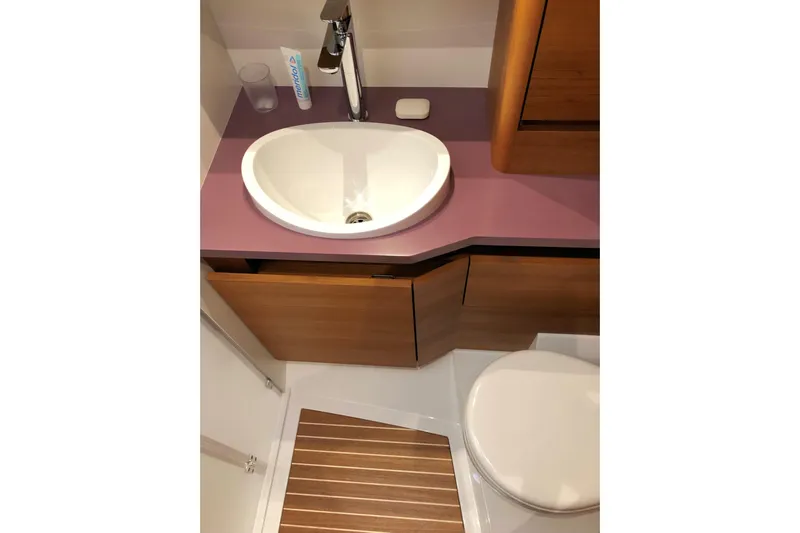 Nausicaä Yacht Photos Pics Luxurious bathroom in 2019 Solaris Yachts 55, featuring modern sink and wooden cabinetry.