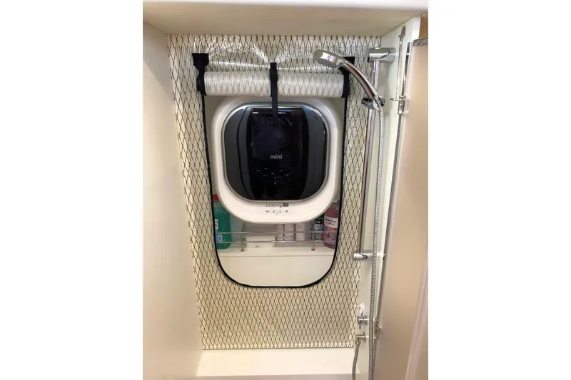 Nausicaä Yacht Photos Pics Interior of 2019 Solaris Yachts 55, featuring a compact shower area with a window.