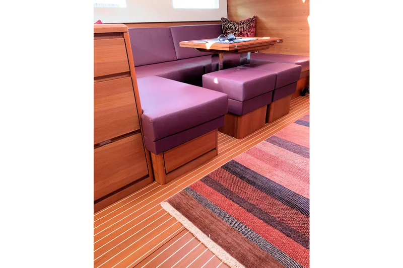 Nausicaä Yacht Photos Pics Luxurious interior of 2019 Solaris Yachts 55 with purple seating and wooden accents.
