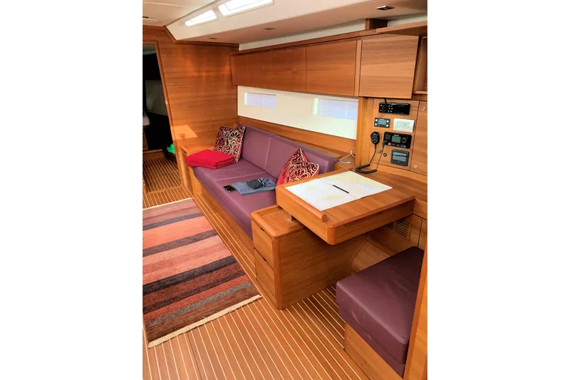 Nausicaä Yacht Photos Pics Luxurious interior of 2019 Solaris Yachts 55 with wooden finish and comfortable seating.