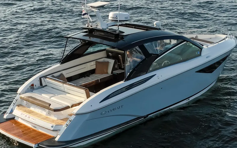 Rancho Agua Yacht Photos Pics 2021 Cobalt A36 luxury boat cruising on open water, featuring sleek design and spacious deck.