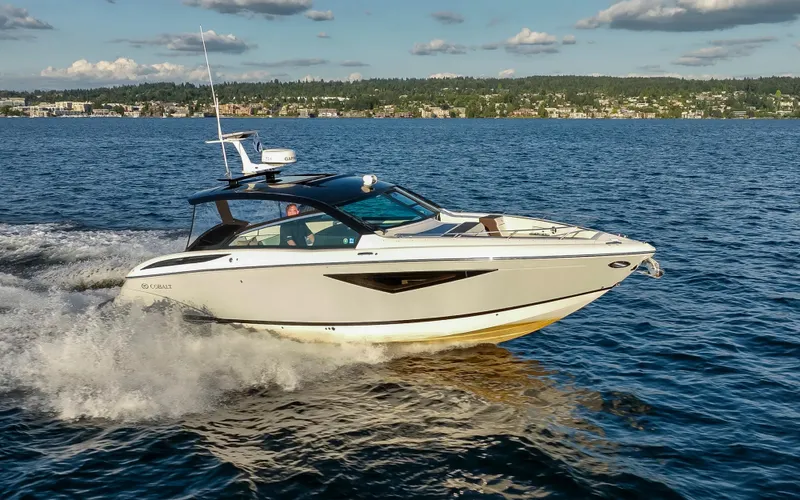 Rancho Agua Yacht Photos Pics 2021 Cobalt A36 boat cruising on a scenic lake under a clear sky.