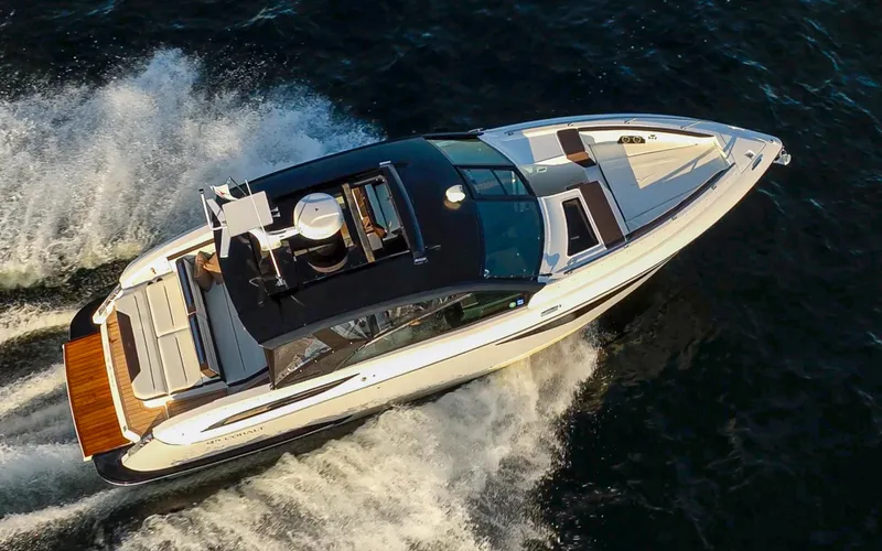 Rancho Agua Yacht Photos Pics 2021 Cobalt A36 yacht cruising on open water, aerial view.