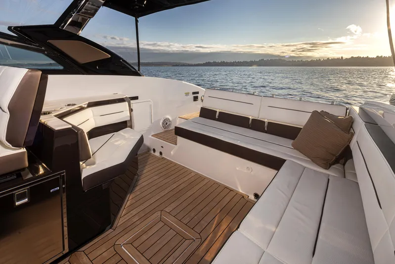Rancho Agua Yacht Photos Pics Luxurious 2021 Cobalt A36 boat interior with elegant seating, overlooking serene waters at sunset.