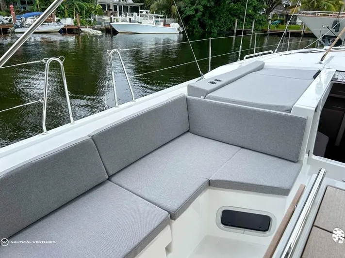  Yacht Photos Pics 2024 Beneteau Oceanis 51.1 yacht with spacious deck seating by the water.