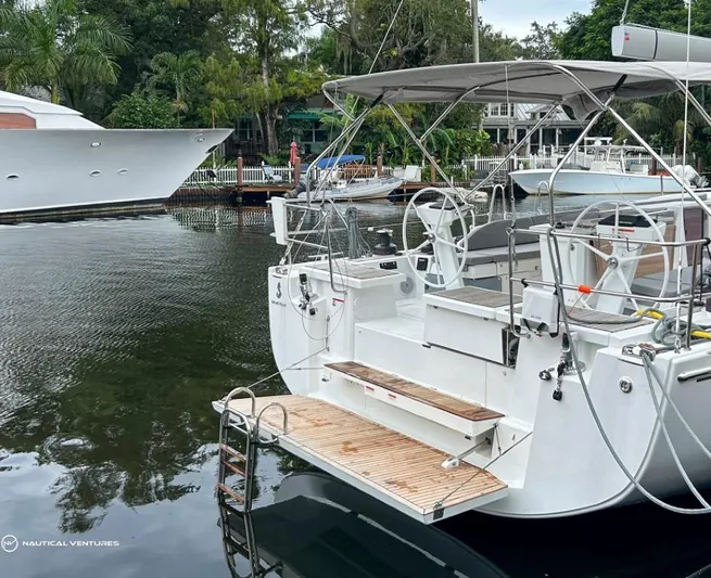  Yacht Photos Pics 2024 Beneteau Oceanis 51.1 yacht docked in a serene marina setting.