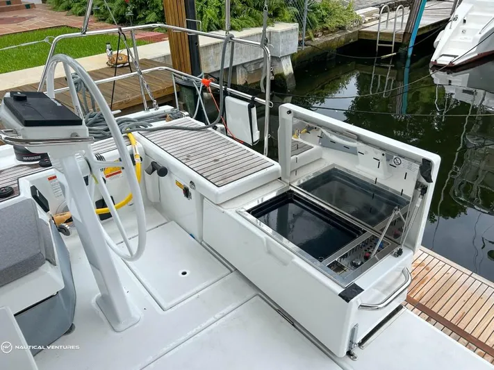  Yacht Photos Pics 2024 Beneteau Oceanis 51.1 yacht deck with open storage compartment.