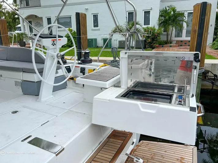  Yacht Photos Pics 2024 Beneteau Oceanis 51.1 yacht deck with outdoor grill and steering wheel.