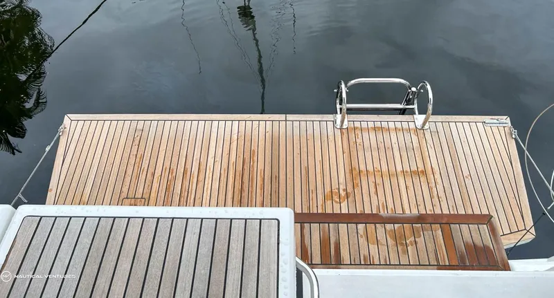  Yacht Photos Pics Teak swim platform on 2024 Beneteau Oceanis 51.1 yacht, featuring stainless steel ladder.
