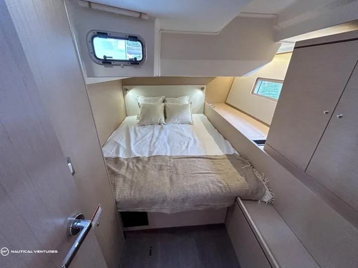  Yacht Photos Pics Luxurious cabin interior of 2024 Beneteau Oceanis 51.1 yacht with cozy bedding.