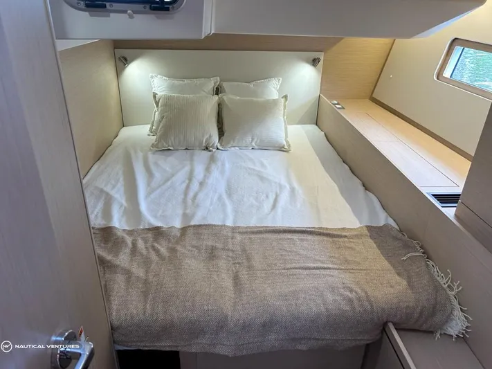  Yacht Photos Pics Luxurious cabin interior of 2024 Beneteau Oceanis 51.1 yacht with cozy bedding.