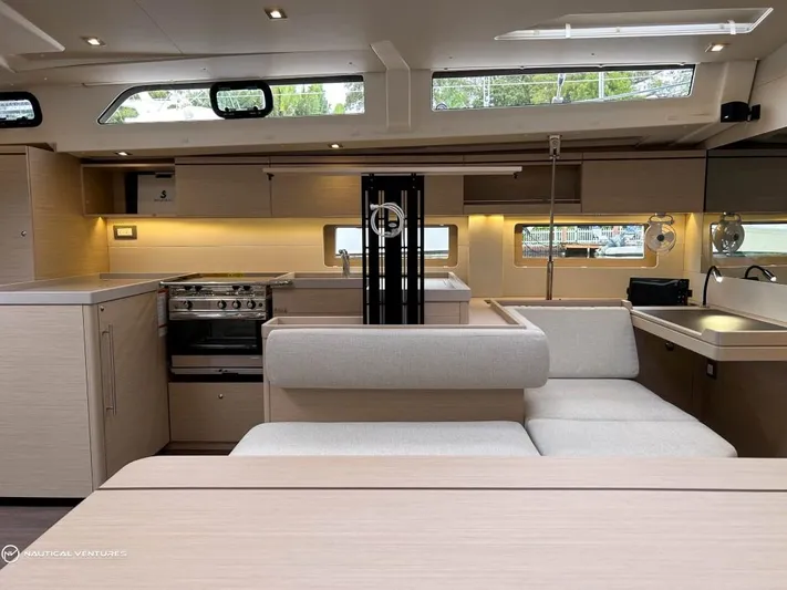  Yacht Photos Pics Luxurious interior of 2024 Beneteau Oceanis 51.1 yacht with modern kitchen and seating area.