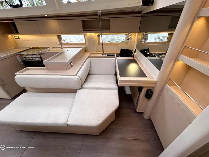  Yacht Photos Pics Luxurious interior of 2024 Beneteau Oceanis 51.1 yacht with modern kitchen and seating area.