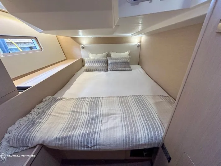  Yacht Photos Pics Luxurious cabin interior of 2024 Beneteau Oceanis 51.1 yacht with cozy bedding.
