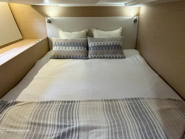  Yacht Photos Pics Luxurious bedroom interior of 2024 Beneteau Oceanis 51.1 yacht with cozy bedding.