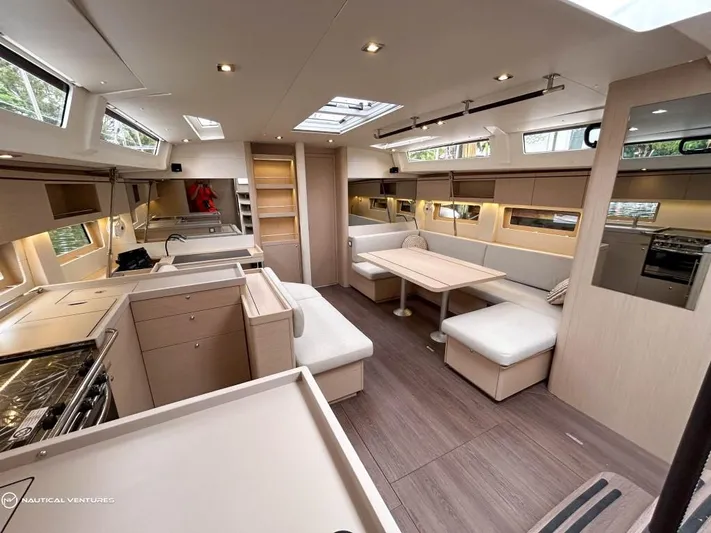  Yacht Photos Pics Luxurious interior of 2024 Beneteau Oceanis 51.1 yacht with modern kitchen and seating area.