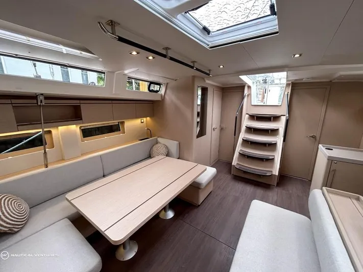  Yacht Photos Pics Luxurious interior of 2024 Beneteau Oceanis 51.1 yacht with modern seating and skylight.
