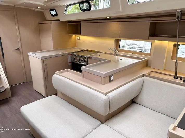  Yacht Photos Pics Luxurious interior of 2024 Beneteau Oceanis 51.1 yacht with modern kitchen and seating area.