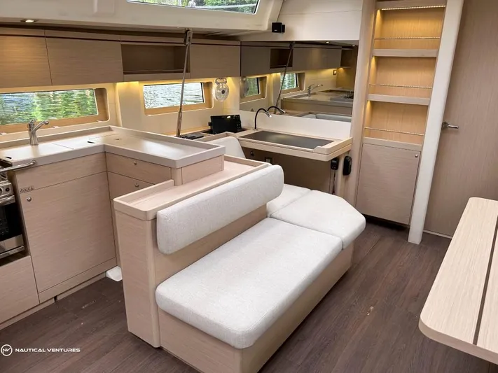  Yacht Photos Pics Luxurious interior of 2024 Beneteau Oceanis 51.1 yacht with modern kitchen and seating area.